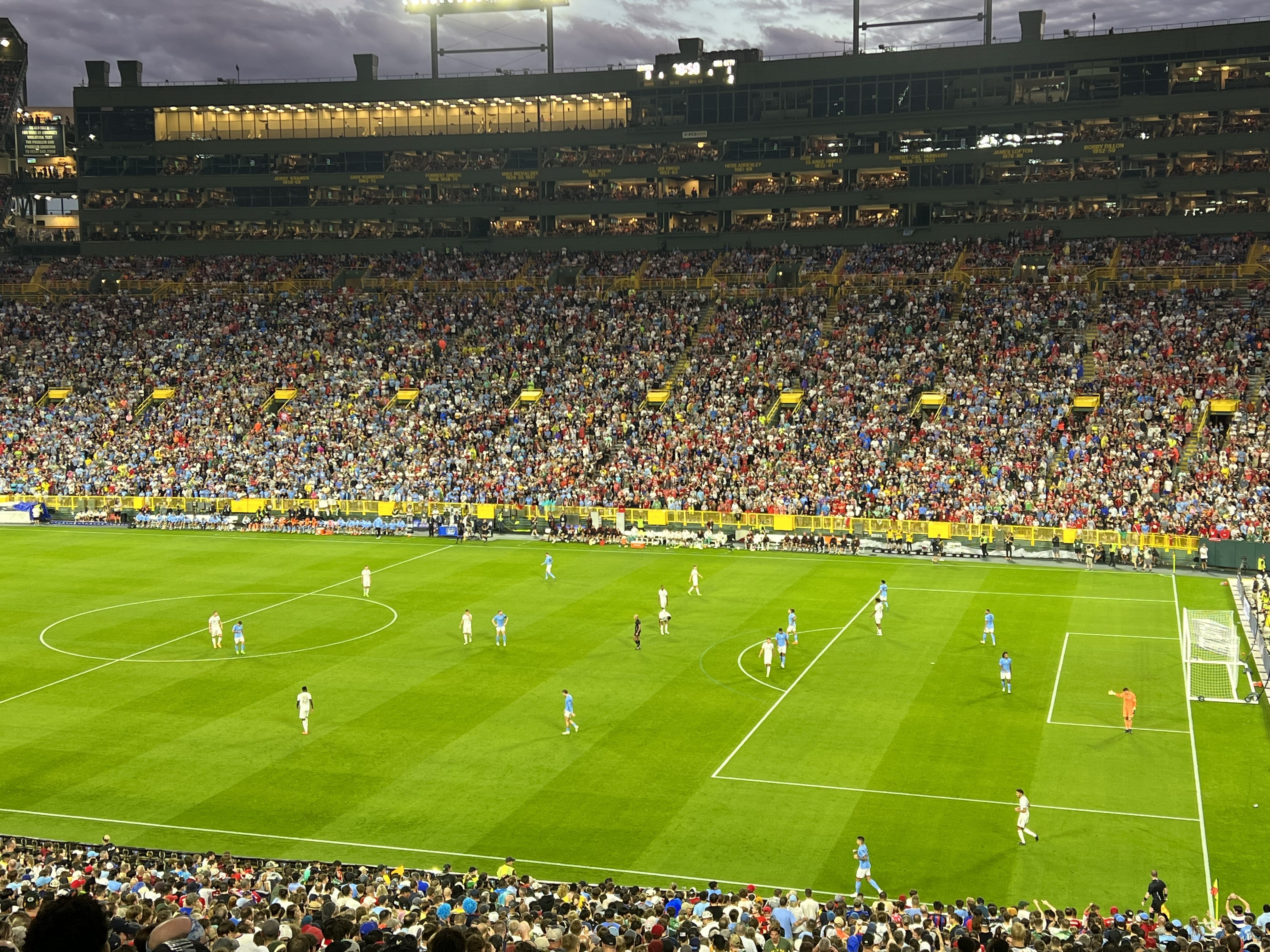 Soccer players on Lambeau field with fans